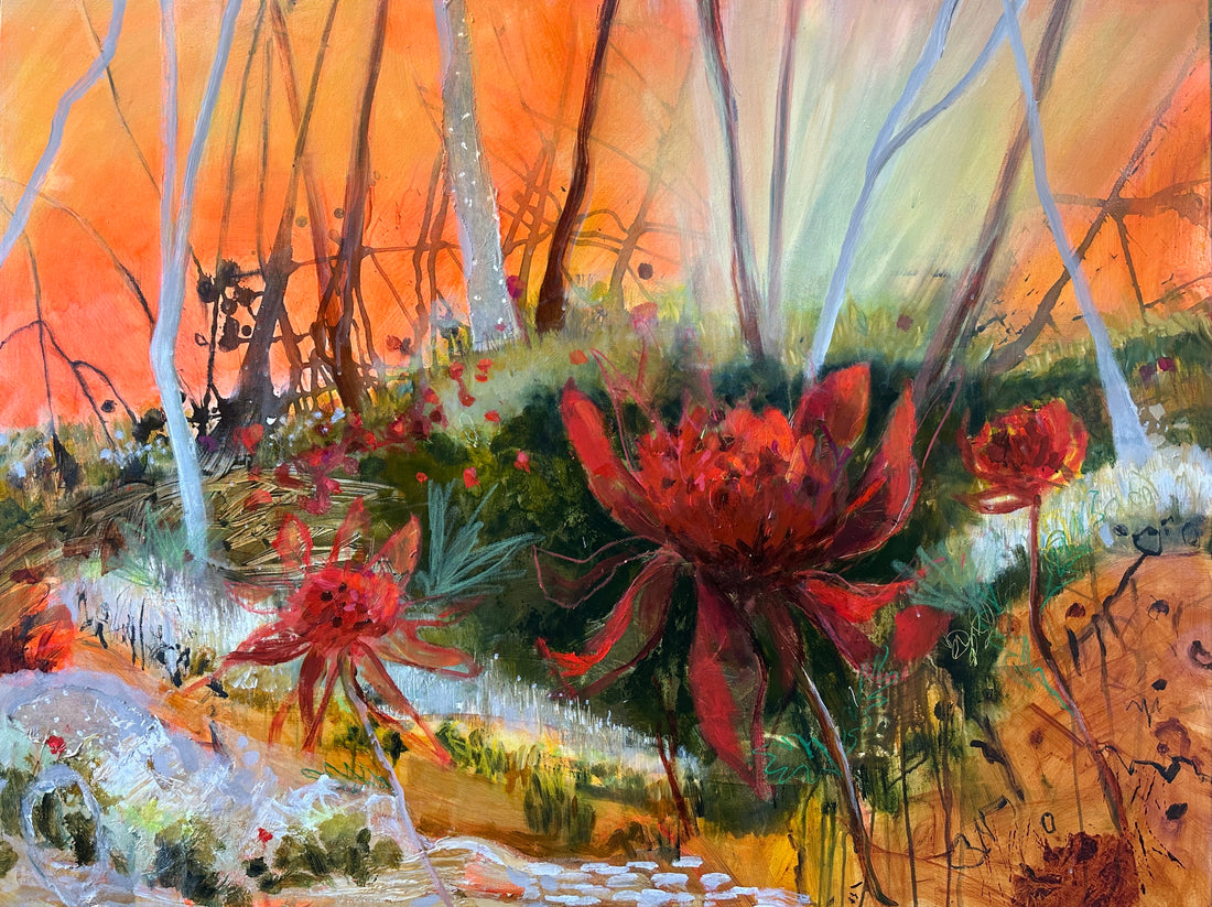 Red flowers in a green landscape with sunset in background