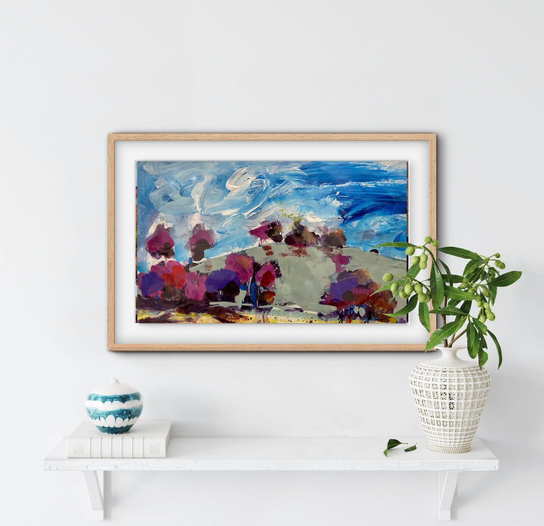 Framed abstract painting on a white wall with decorative vases and a plant below.