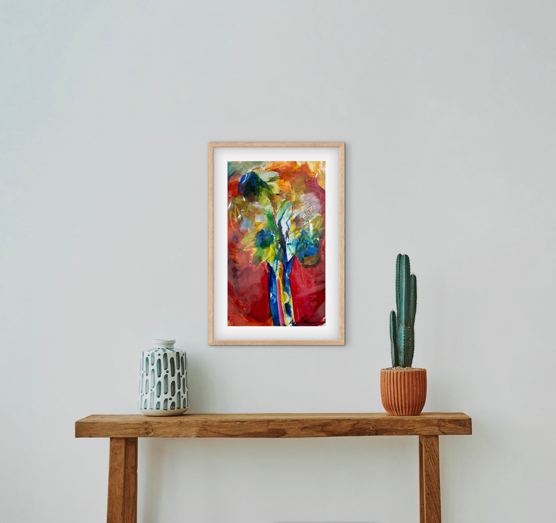 Coloured tree on a red background above a wooden table.