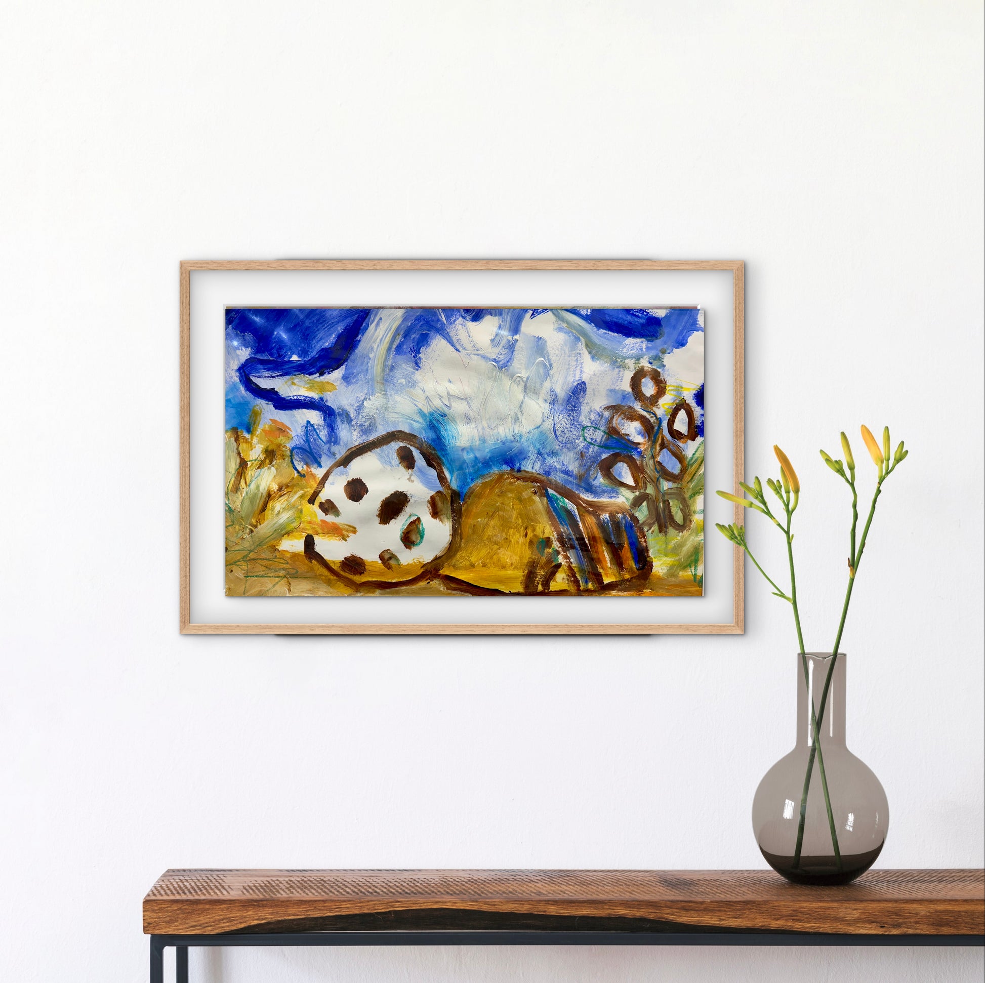 Framed abstract painting on a wall above a wooden console table with a vase.
