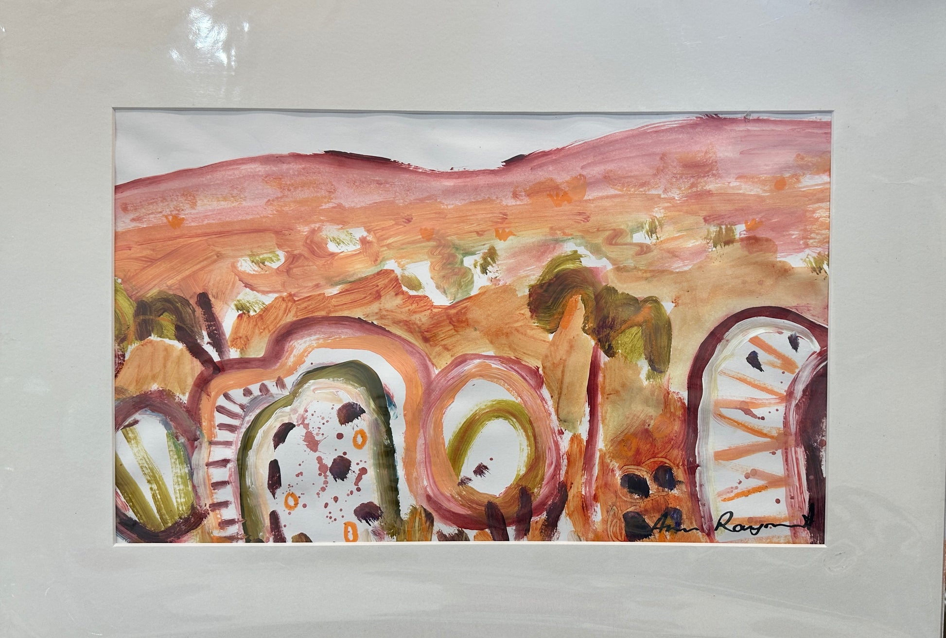 Framed abstract artwork with earthy tones on a plain background