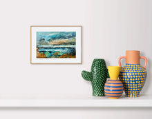 Framed artwork on a wall with decorative vases below